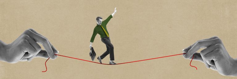 business person walking on string